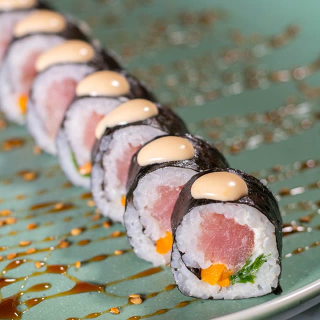 505 · Hot Spicy Tuna Roll with tuna, cucumber, leek, special sauce, masago, coated in sesame (spicy)